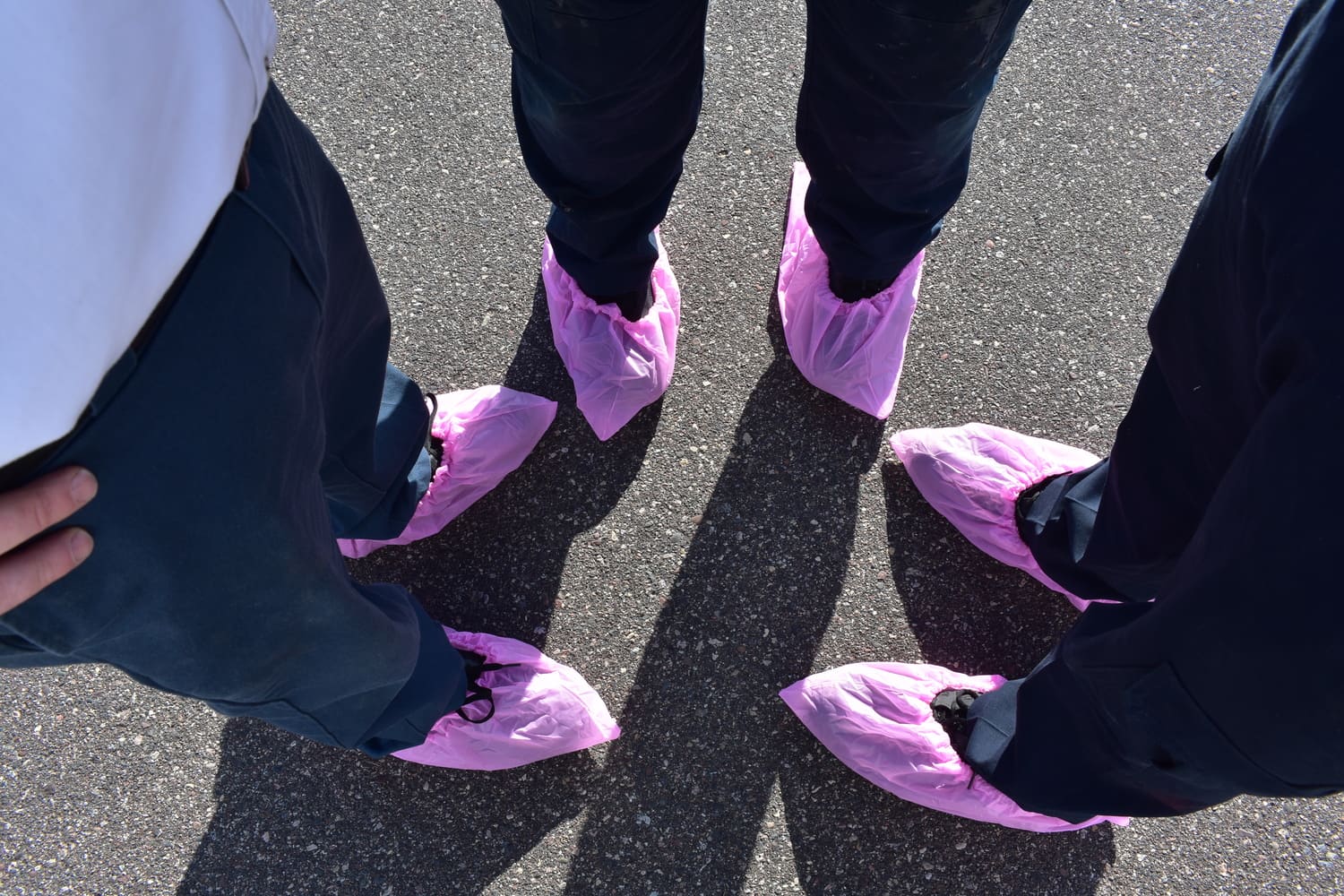 Plumb Right team supporting Breast Cancer Awareness Month with pink shoe covers