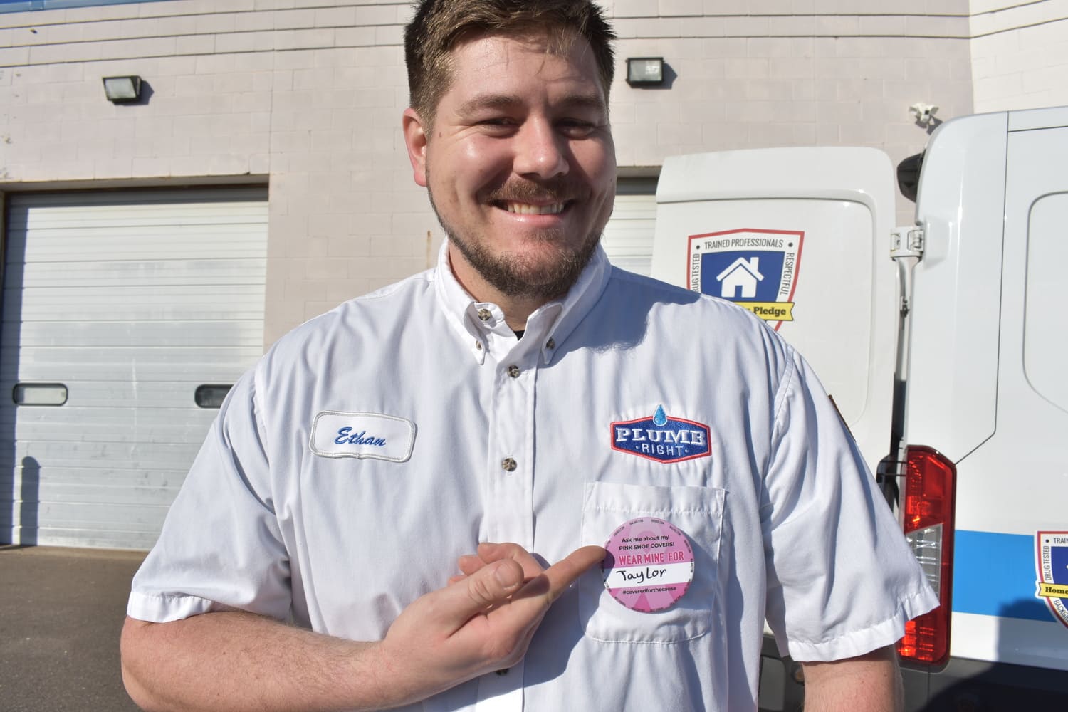 Plumb Right technician wearing pink shoe covers for Breast Cancer Awareness Month